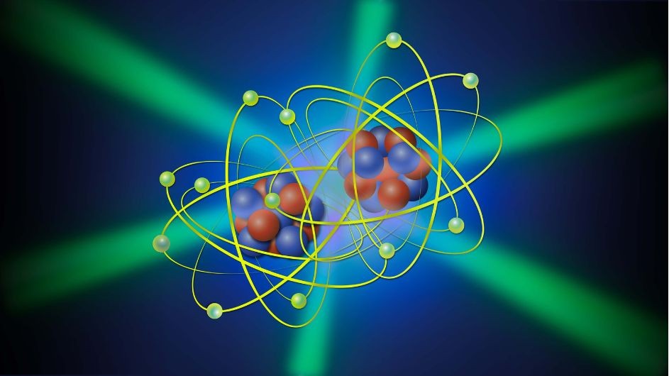 A molecule of two carbon atoms with electrons circling and three green laser beams passing through