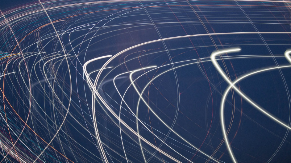 Credit: Pexels / Pixabay Image of white light arcing along a blue background, to represent ballistic flow.