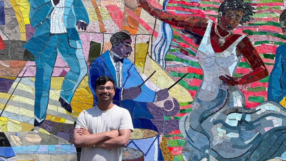 Arkajit Mandal in front of a colorful mural