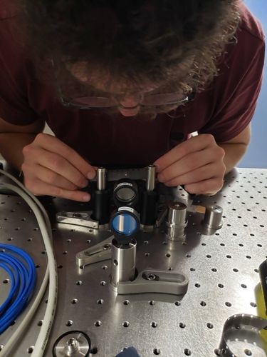 Niccolo Bigagli adjusting an optical lens