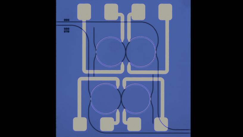 Microscope Image of SiN coupled-ring device. The mode interaction position is thermally tuned via integrated heaters to turn on and off the degenerate parametric oscillator for random number generation. 