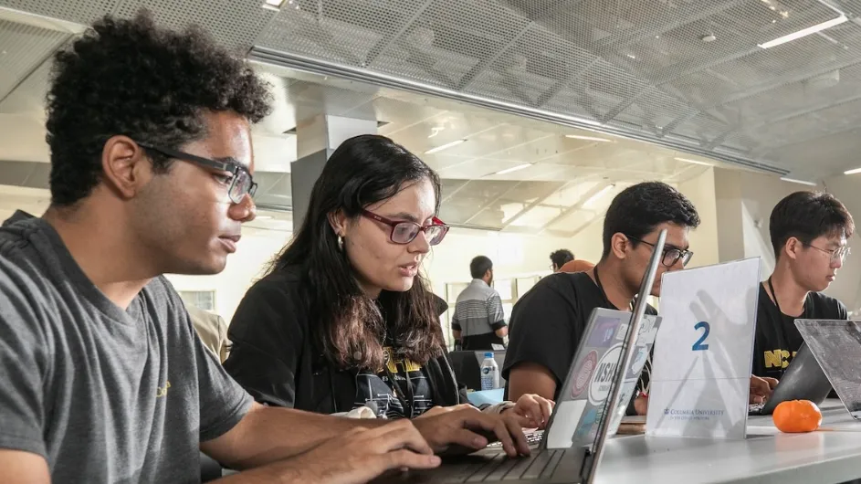 Students working on their laptops during the NYC HAQ quantum hackathon. 