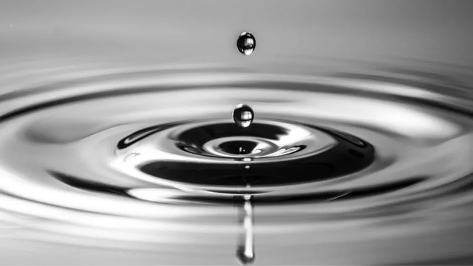 Black and white photograph of two water droplets and ripples, as an abstract representation of many-body localization