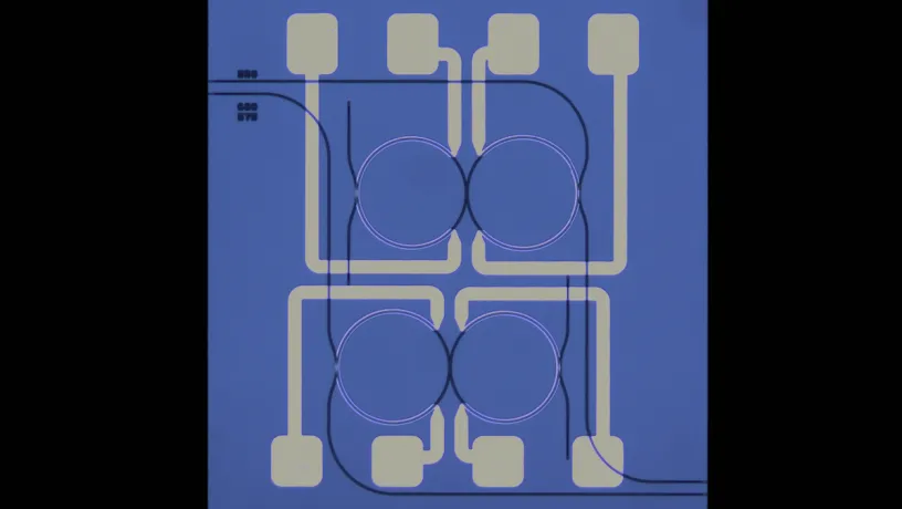 Microscope Image of SiN coupled-ring device. The mode interaction position is thermally tuned via integrated heaters to turn on and off the degenerate parametric oscillator for random number generation. 